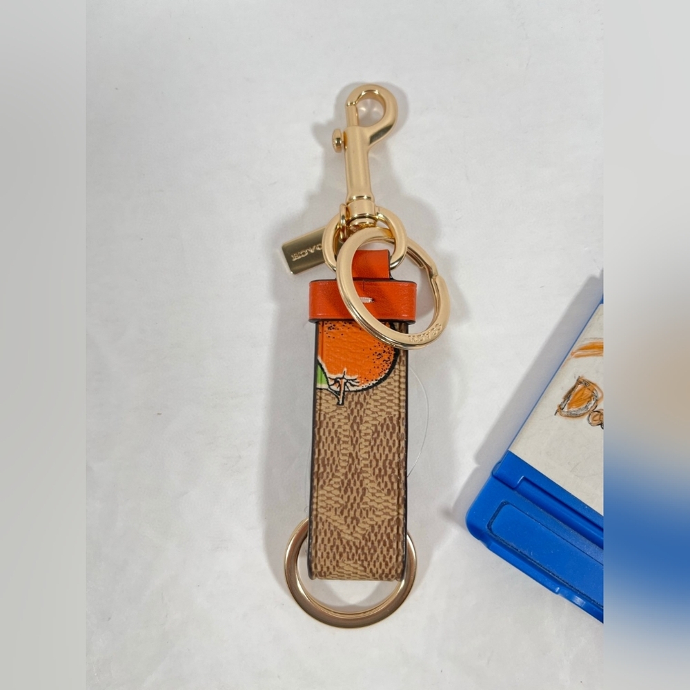 Coach Trigger Snap Bag Charm In Signature Canvas With Orange Print NWT - Picture 2 of 3